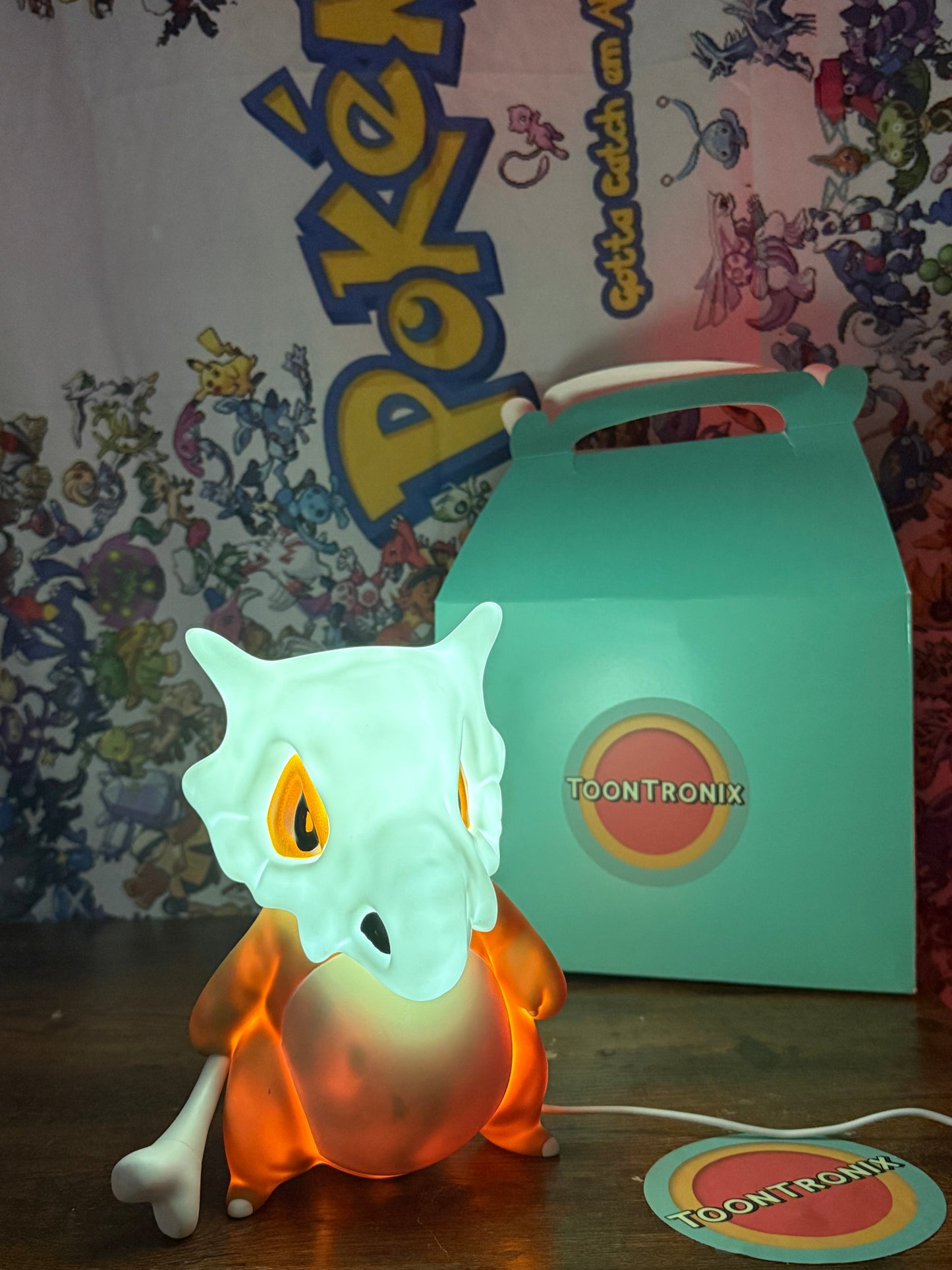 8" Cubone Statue USB desk lamp with glowing LED light and Toontronix packaging against Pokémon background