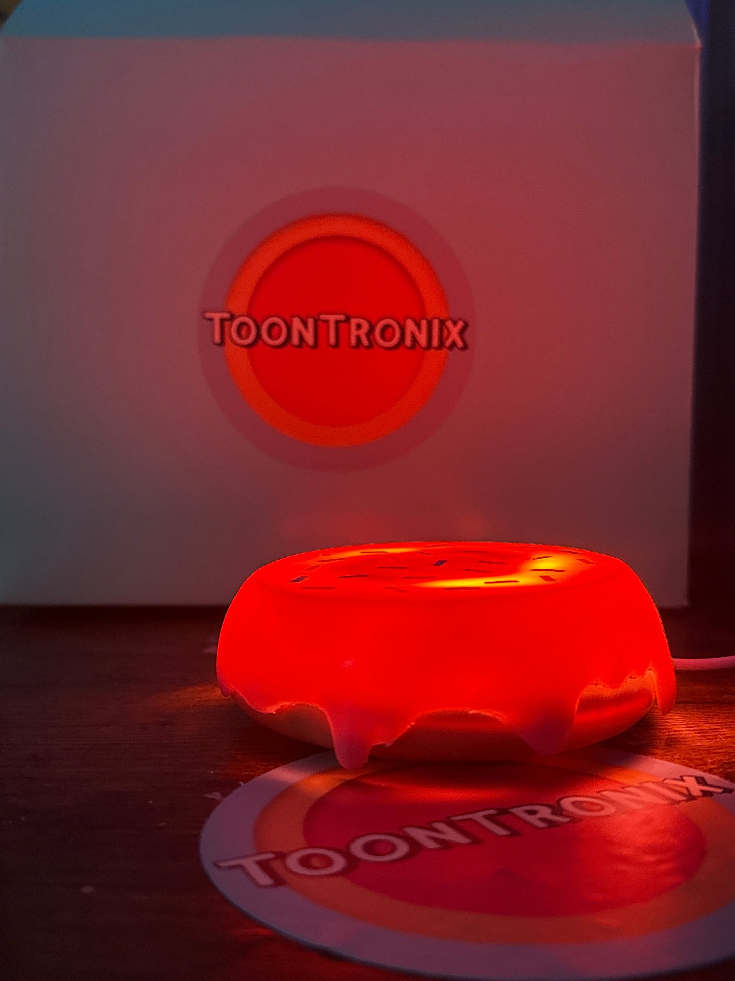6" or 9" flat donut LED desk lamp with vibrant cartoon design and USB power, glowing red on a wooden surface.