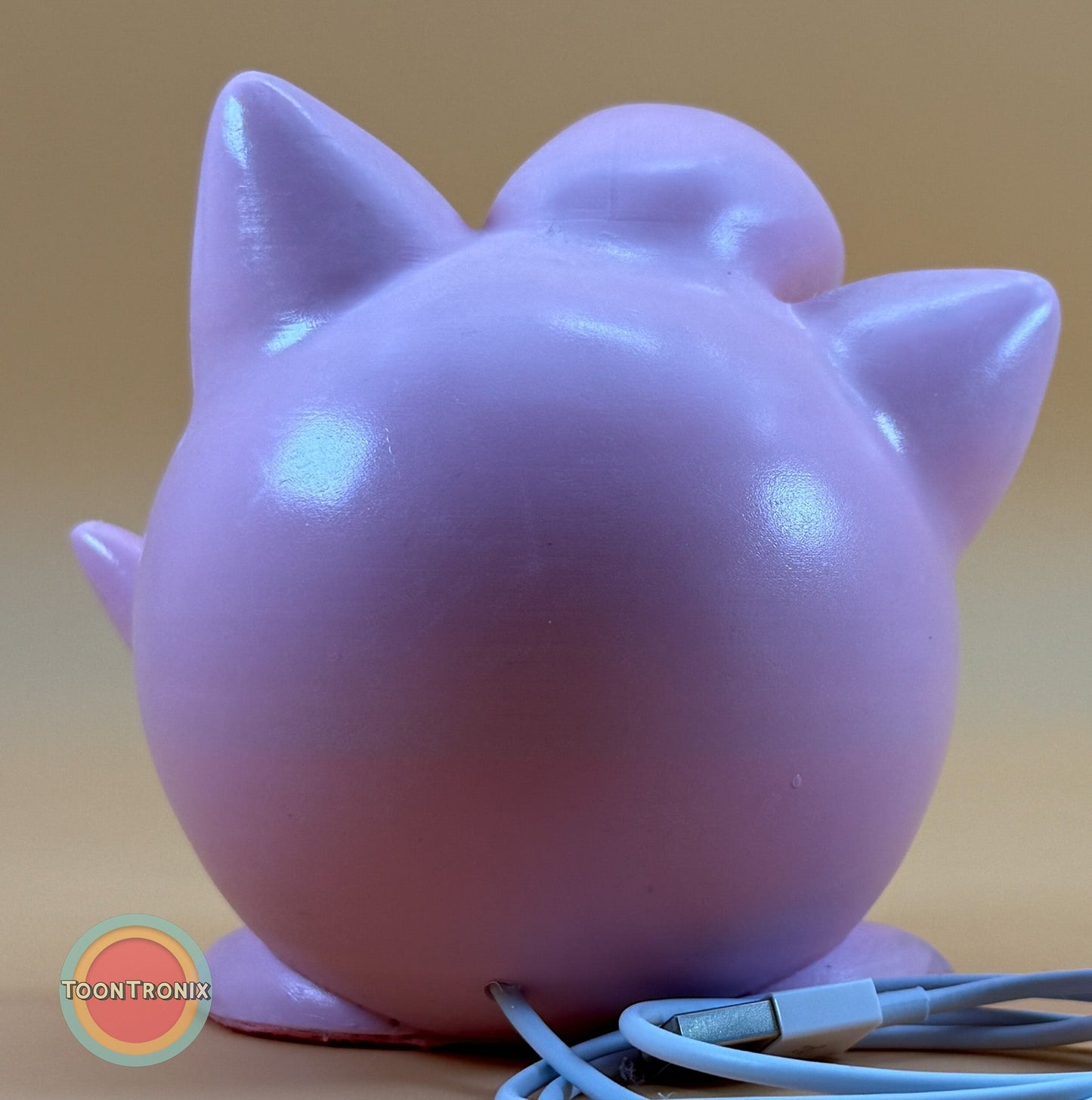 Back view of 4.6" Jigglypuff Pokemon statue USB desk lamp with built-in USB cord and wood-like finish