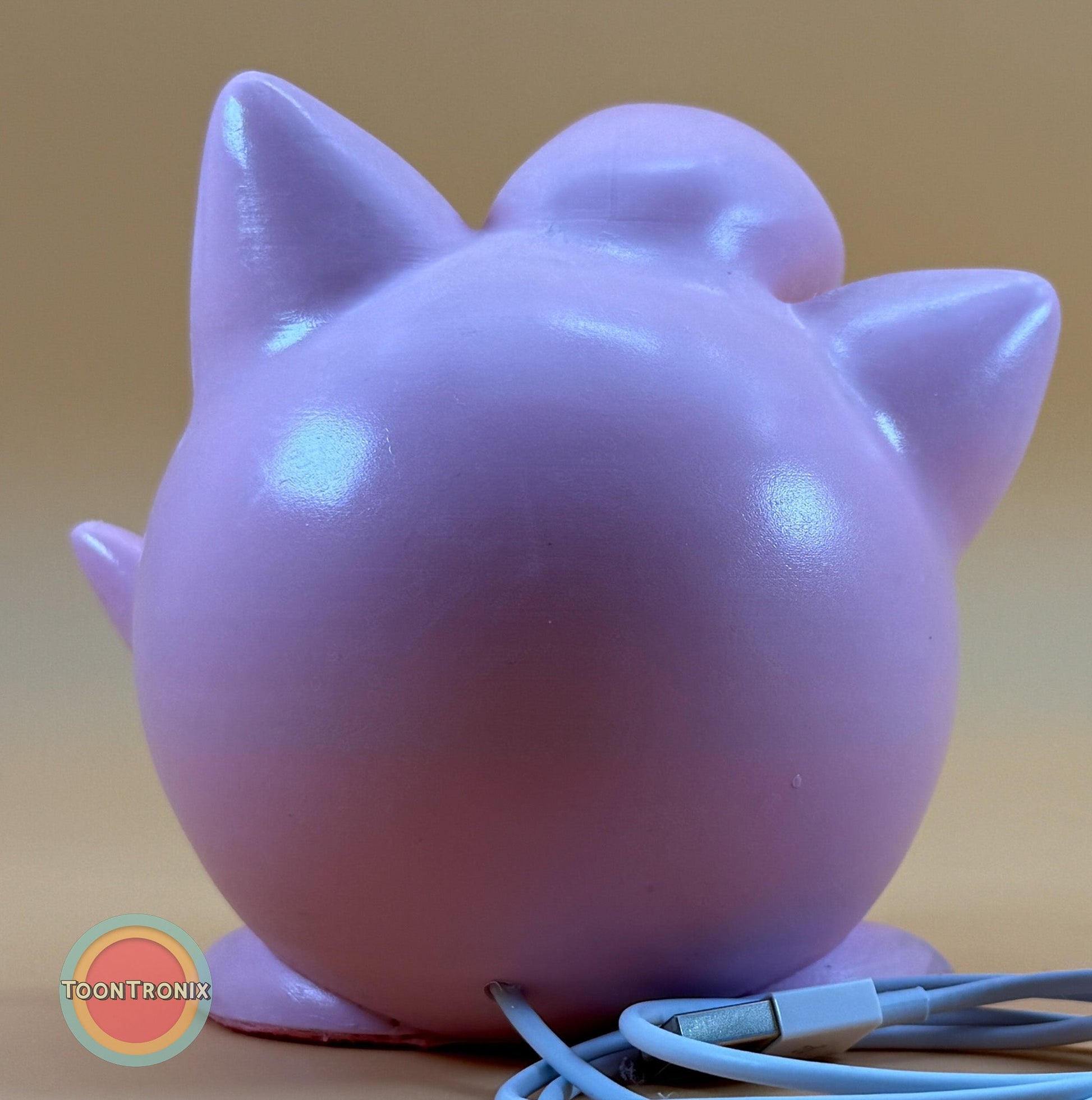Back view of 4.6" Jigglypuff Pokemon statue USB desk lamp with built-in USB cord and wood-like finish