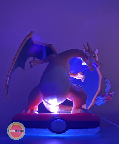 4" Charizard Pokemon statue desk lamp with USB cord and blue lighting on Pokeball base