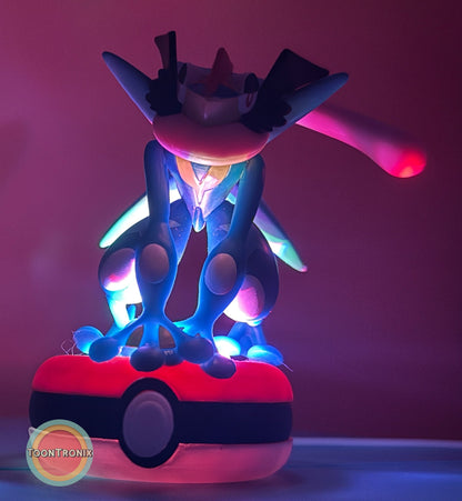 3" Greninja Pokémon USB desk lamp glowing with vibrant blue and pink light on a Poké Ball base