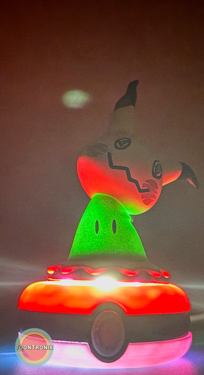 3" Mimikyu Pokemon statue USB desk lamp glowing in red and green colors on a Pokeball base
