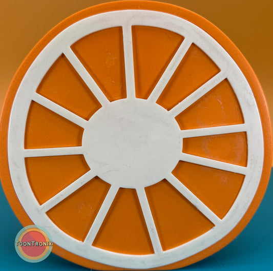 Close-up of the base of a 6" or 9" orange desk food lamp featuring a white segmented design resembling an orange slice, made with a woodified finish.