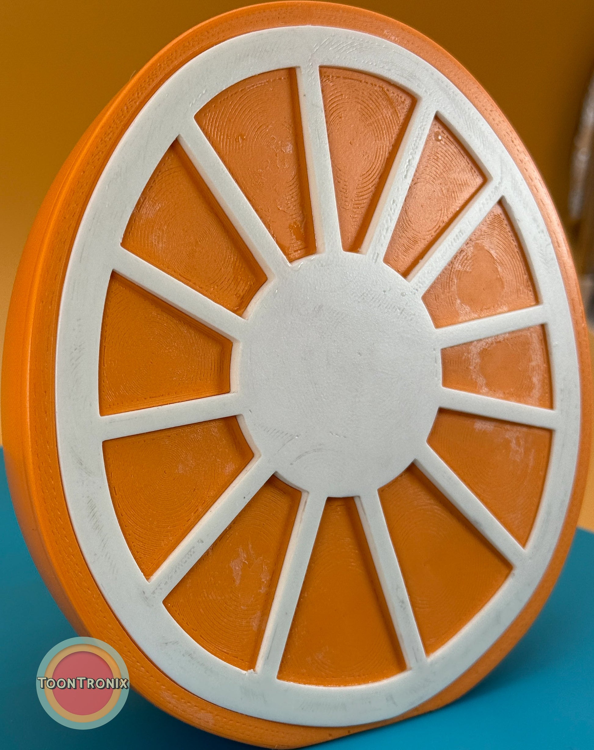 Orange desk food lamp shaped like a sliced orange with white segment dividers and vibrant retro design