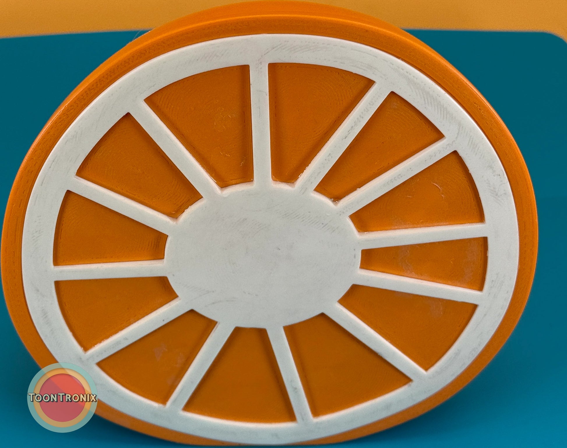 Top view of a 6" or 9" orange desk food lamp shaped like an orange slice with wood-like finish and built-in USB cord.