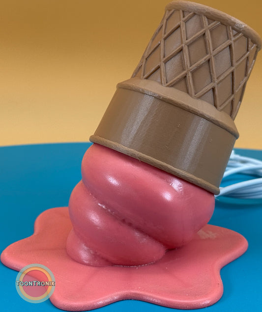 Pink ice cream cone desk lamp with wood finish and built-in USB cord on blue surface