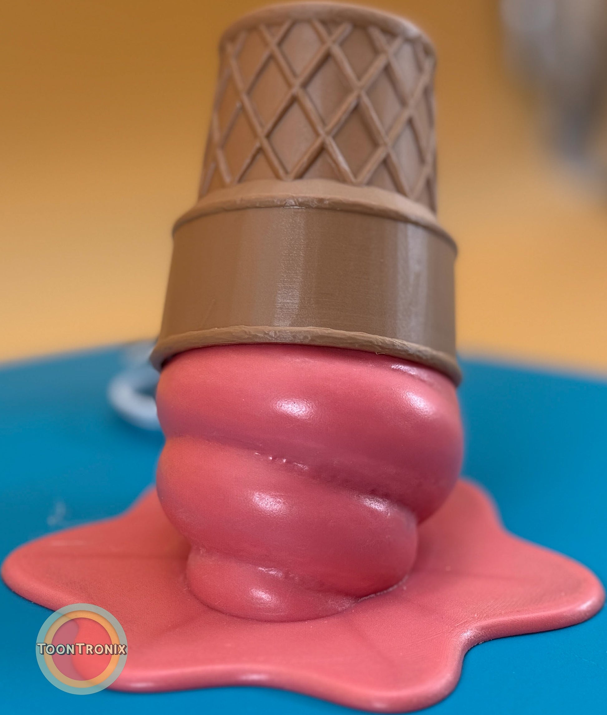 Melting pink ice cream cone desk lamp with wood-like finish and built-in USB cord.