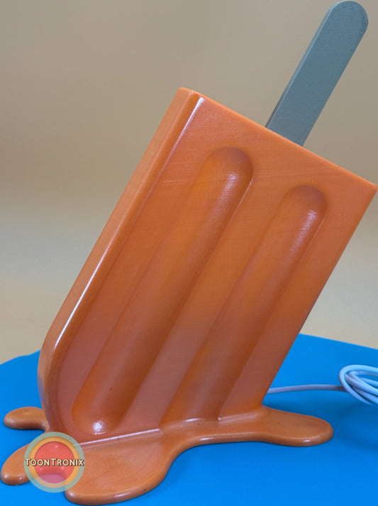 6" or 9" Popsicle Desk Lamp melting orange design with USB cord on blue surface