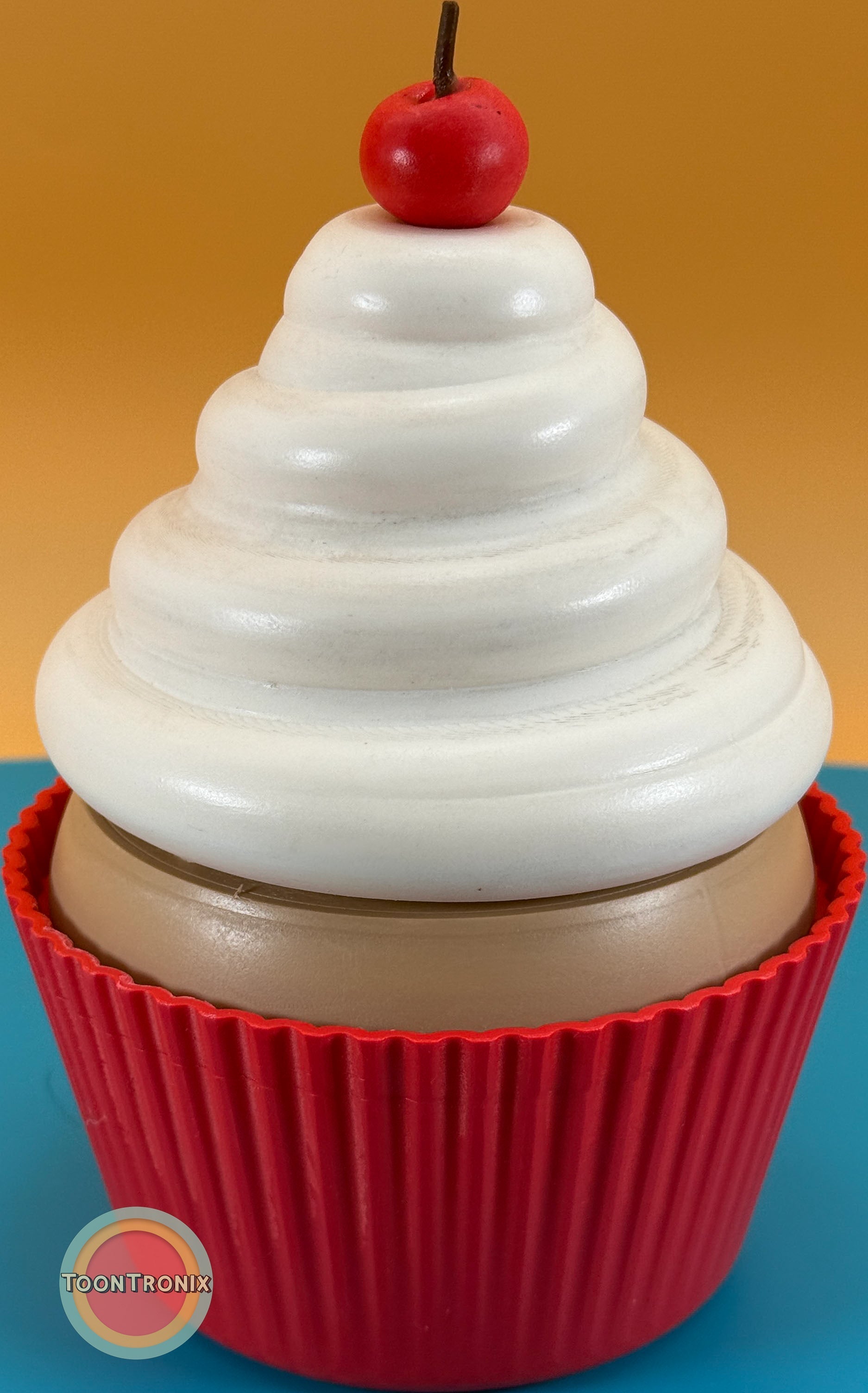 6-inch cupcake desk lamp with white swirl frosting and red base topped with a cherry-shaped detail