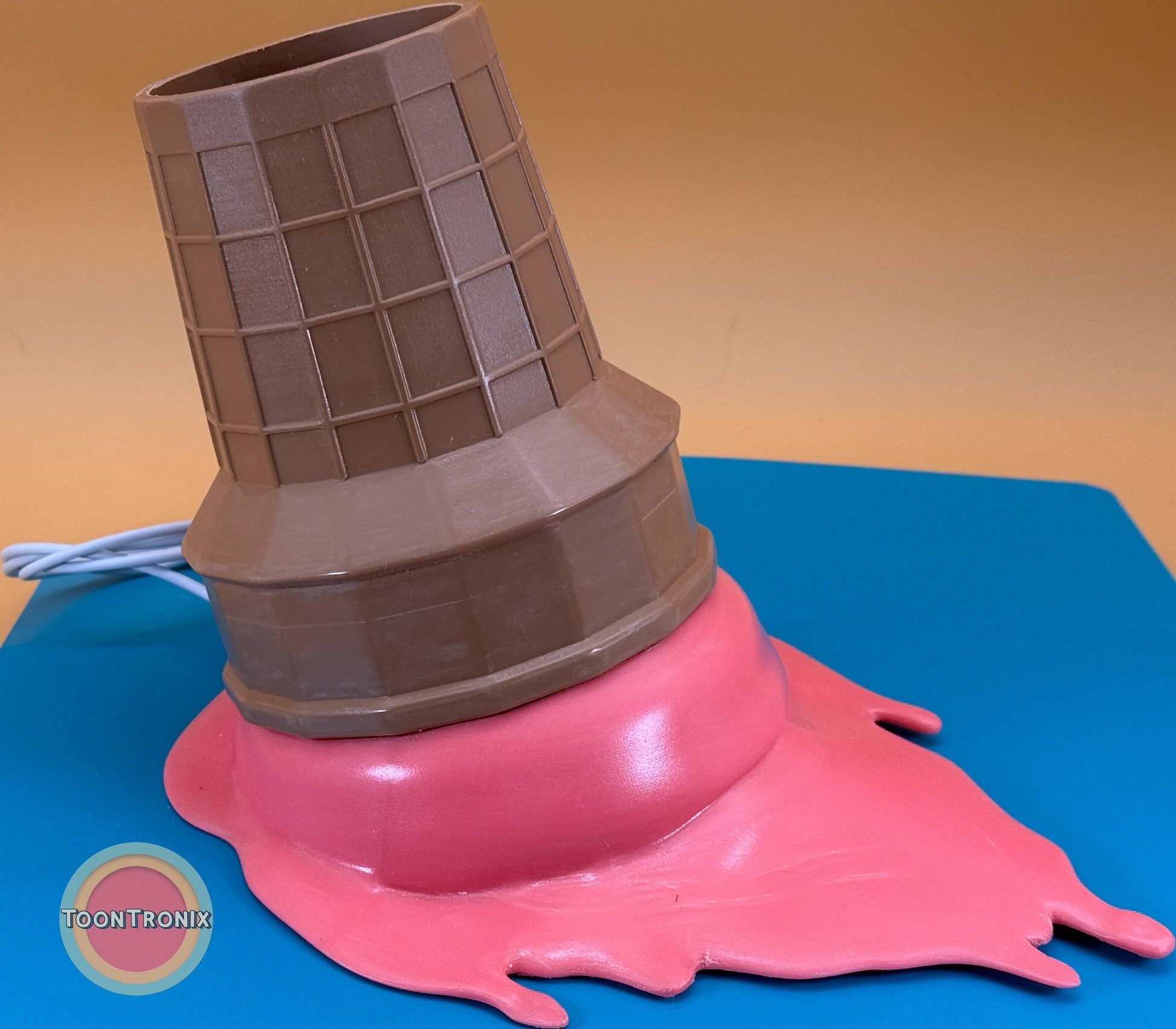 Melting ice cream cone desk lamp with built-in USB cord in vibrant retro cartoon style