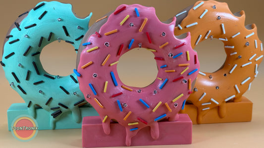 Colorful 6" or 9" donut-shaped desk lamps with sprinkles and USB power cord in blue, pink, and orange designs