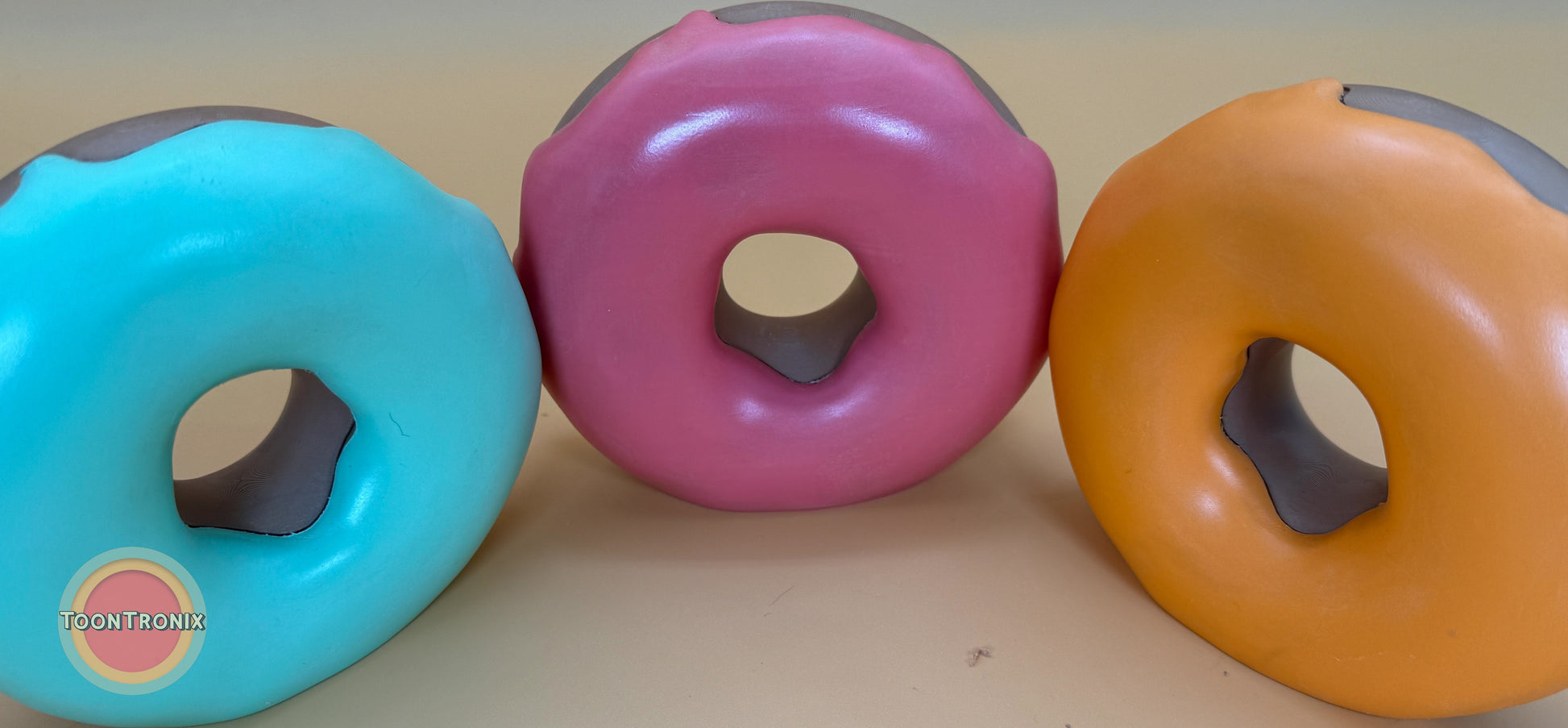 Colorful retro donut desk lamps in blue, pink, and orange with built-in USB cords, available in 6" or 9" sizes.