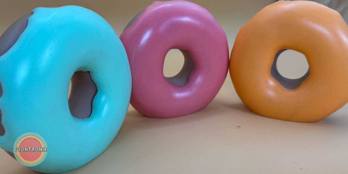 Colorful donut-shaped desk lamps in blue, pink, and orange with a retro cartoon style and built-in USB power.