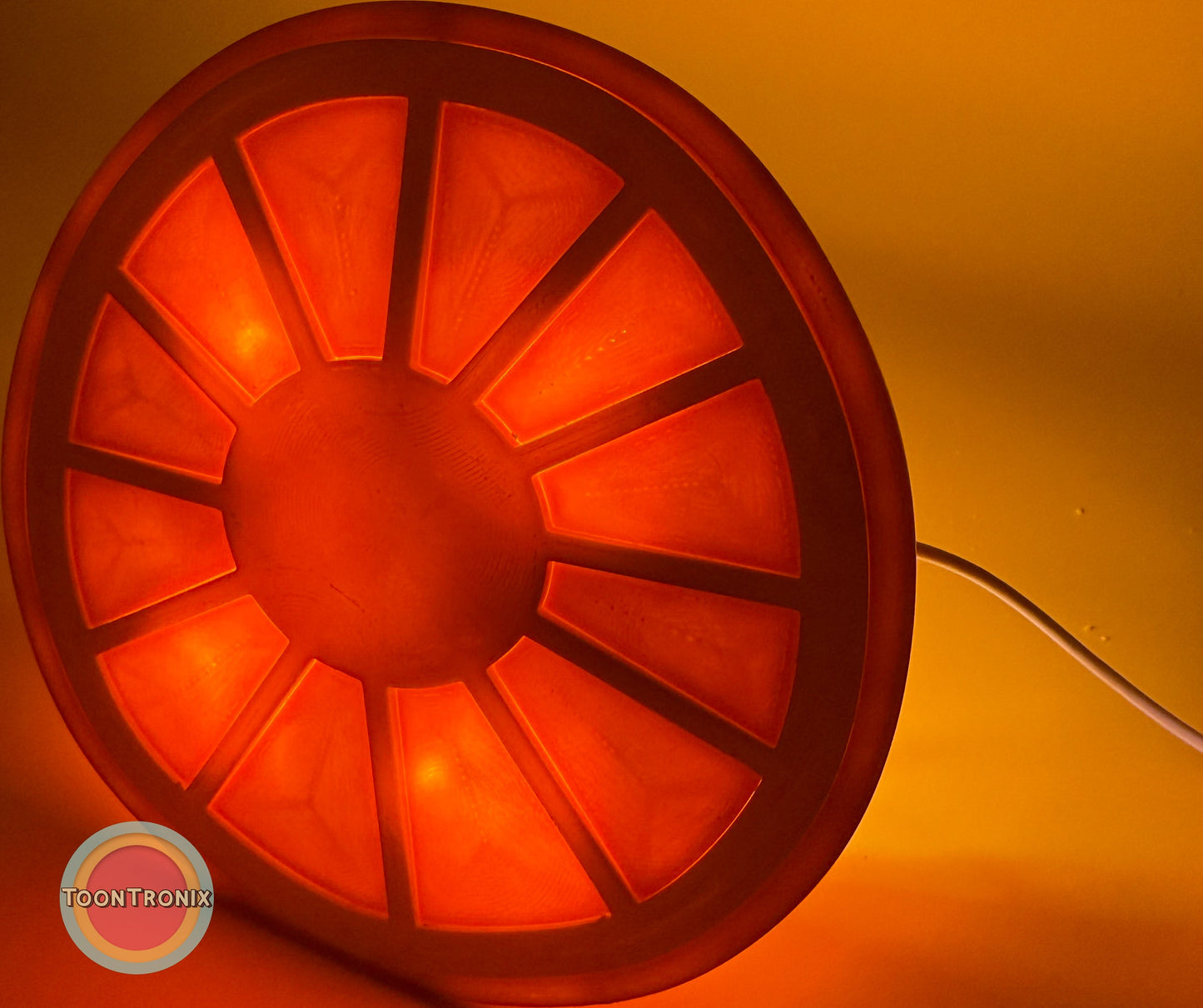 Orange desk food lamp glowing with segmented design and warm light