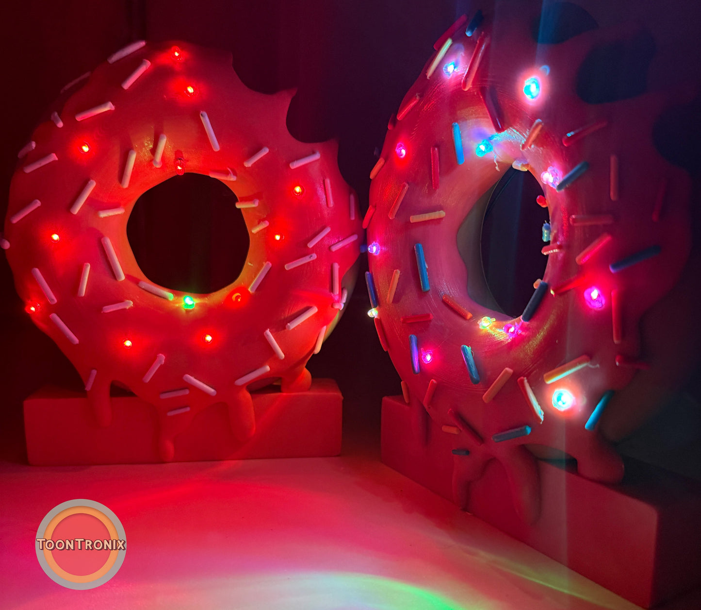 6" and 9" donut-shaped desk lamps with colorful sprinkles and built-in LED lights on a dark background