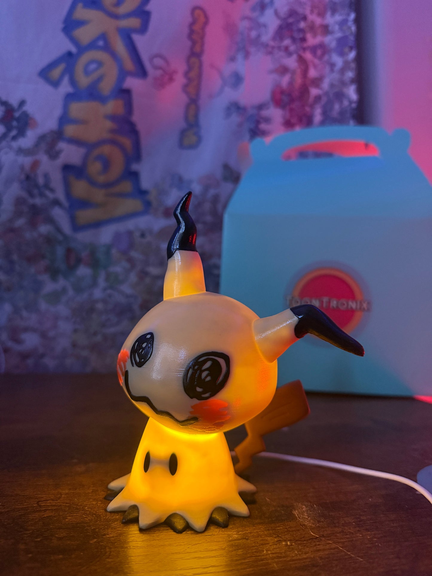 6" Mimikyu Pokemon statue LED desk lamp with USB cord, wood-like finish, glowing yellow light