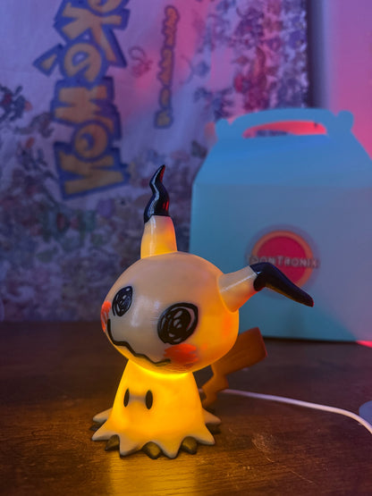 6" Mimikyu Pokemon statue LED desk lamp with USB cord, wood-like finish, glowing yellow light