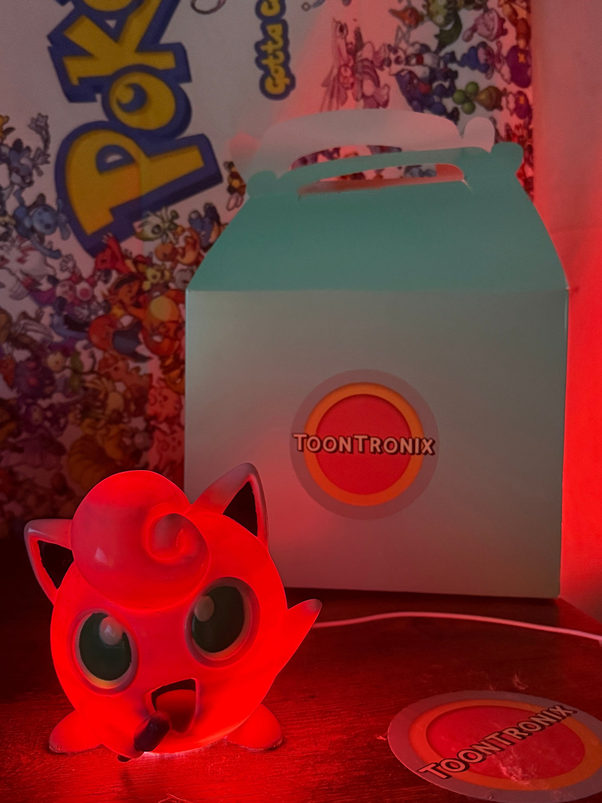 4.6" Jigglypuff Desk Lamp glowing red with Toontronix packaging in the background
