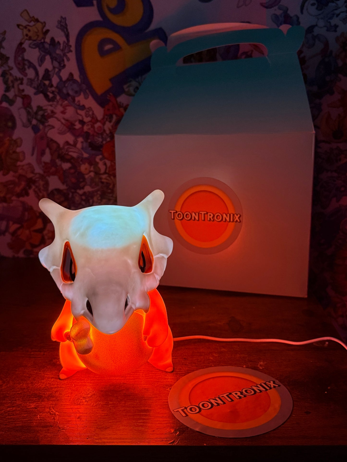 6" Cubone desk lamp figure glowing orange with USB cord and Toontronix packaging in background