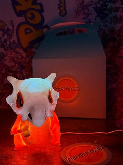 6" Cubone Pokémon statue toy figure glowing orange USB desk lamp with Toontronix packaging in background