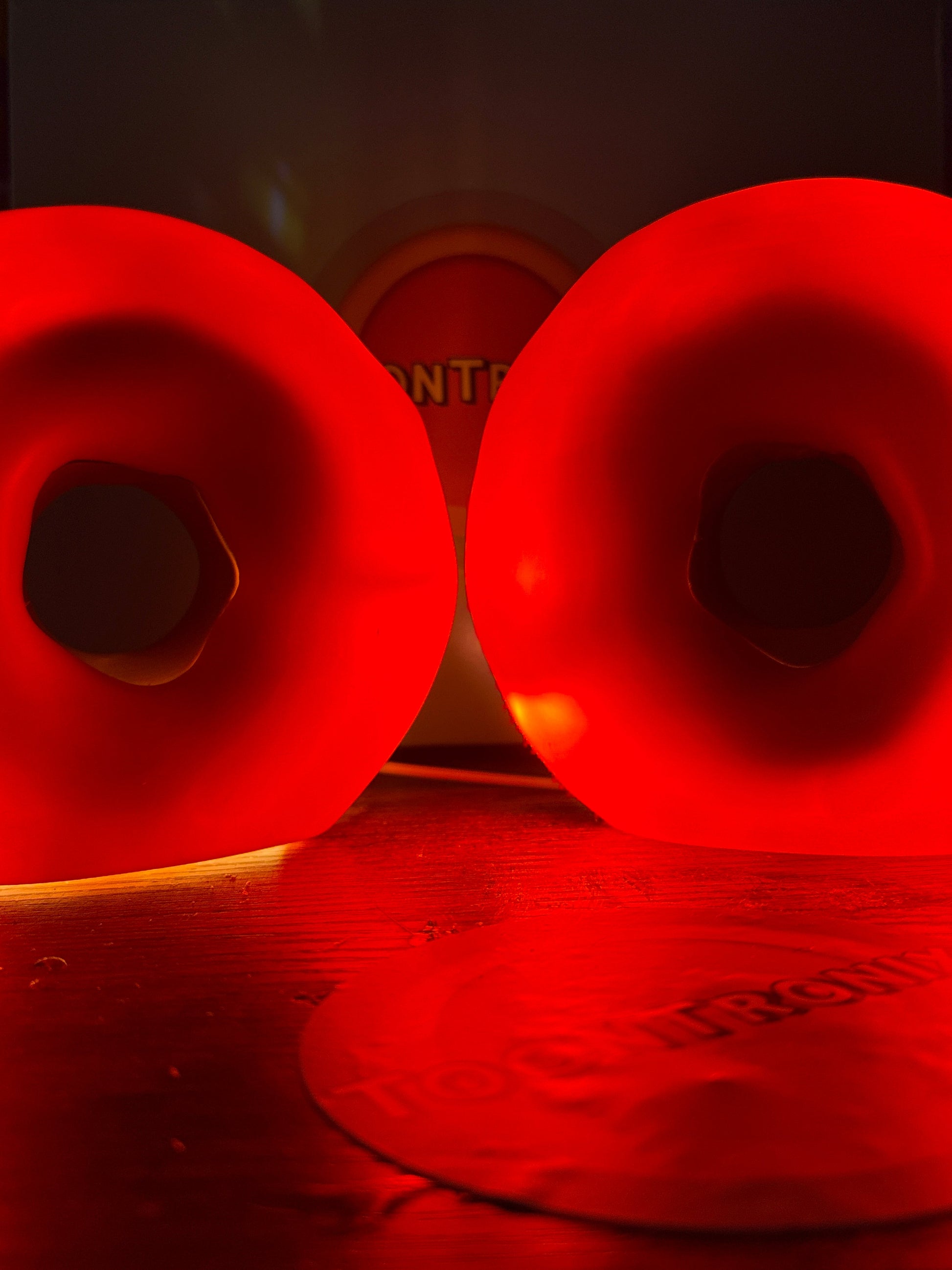 Red glowing 6" and 9" donut desk lamps with LED light and USB power on wooden surface