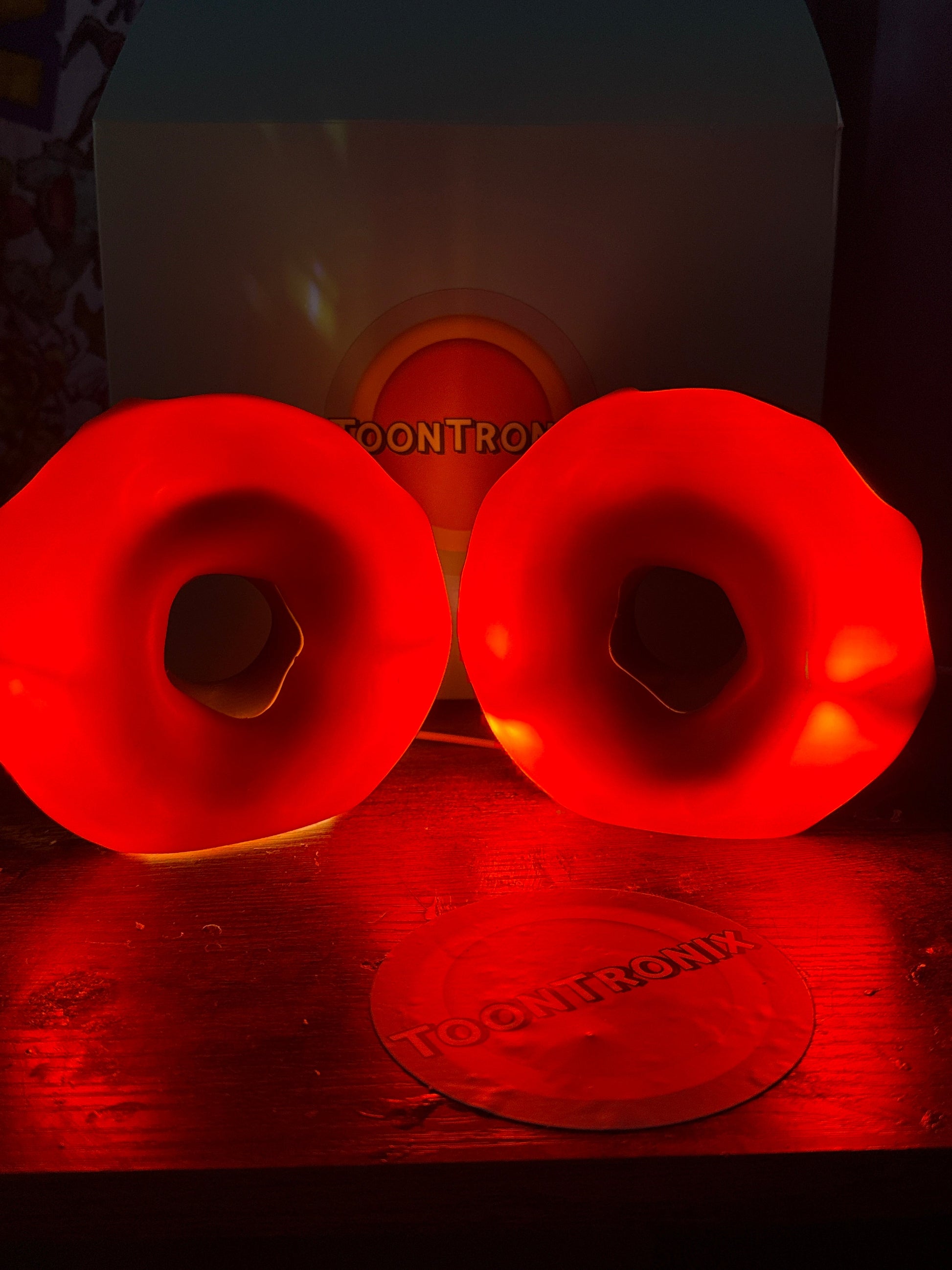 Red glowing 6-inch and 9-inch donut desk lamp with built-in USB cord and wood-like finish